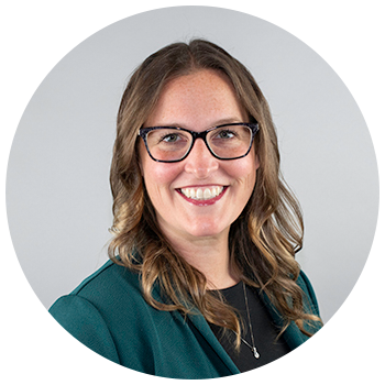 Professional headshot of woman wearing glasses smiling