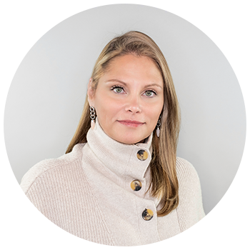 Professional headshot of woman wearing white sweater