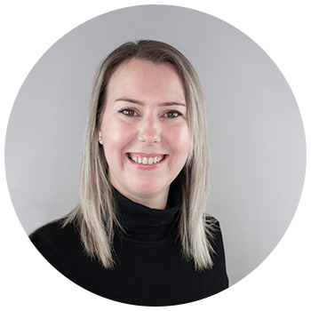 Professional headshot of woman smiling on neutral background