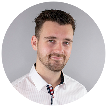 Professional headshot of man on neutral background