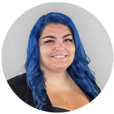 Professional headshot of woman with blue hair