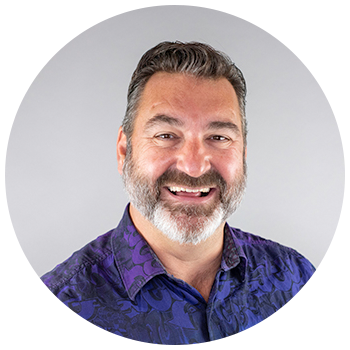 Professional headshot of man smiling with beard
